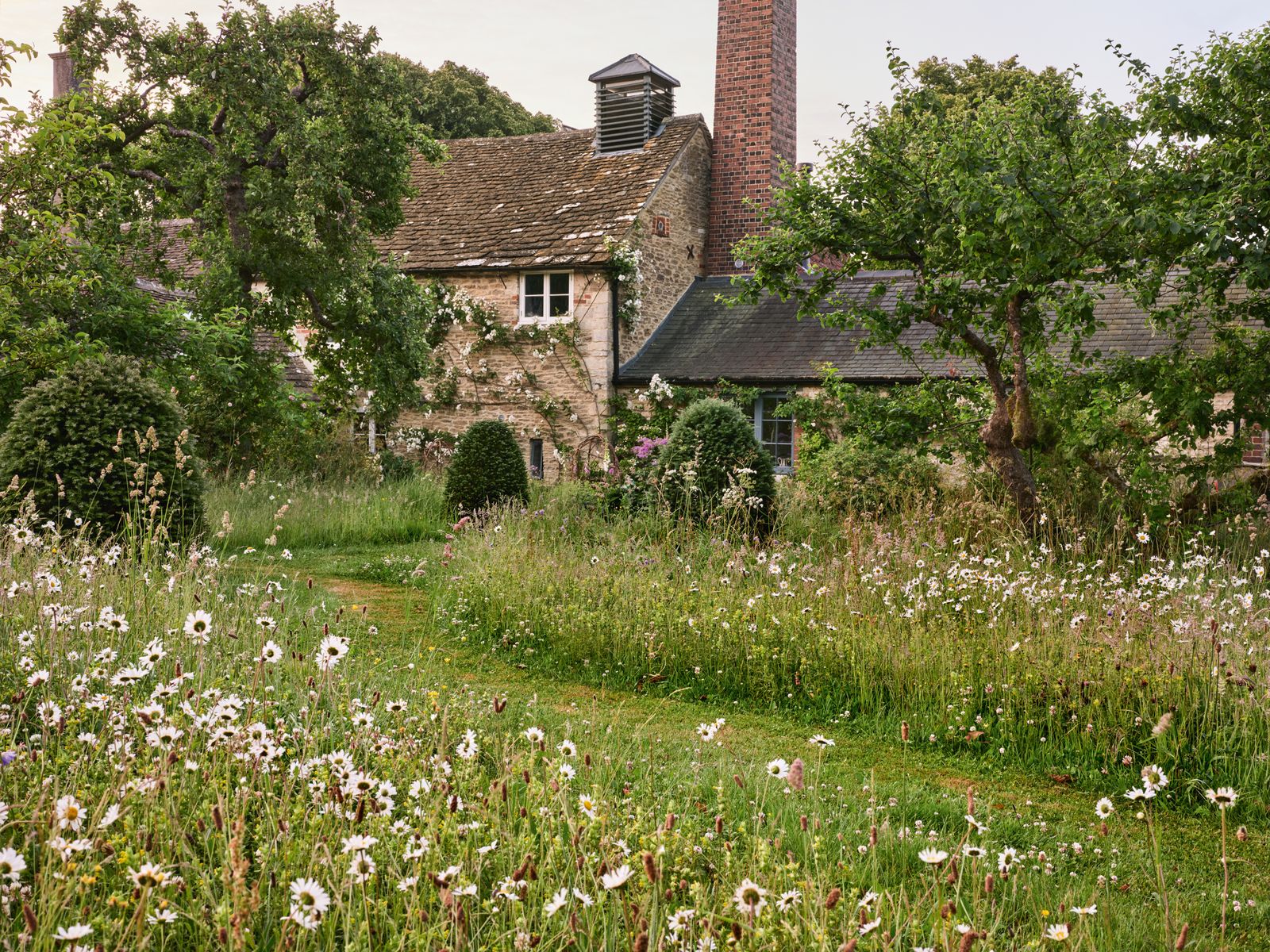Image may contain Architecture Building Cottage House Housing Grass Plant Field Grassland Nature and Outdoors