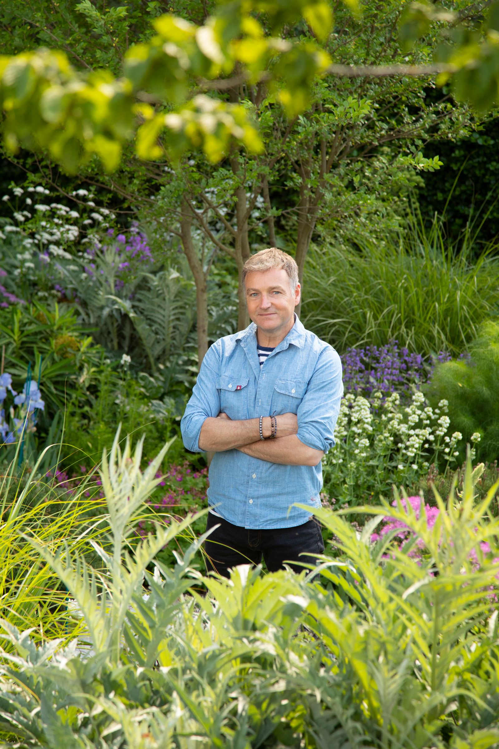 Image may contain Chris Beardshaw Garden Nature Outdoors Gardening Adult Person Herbal Herbs Plant and Vegetation