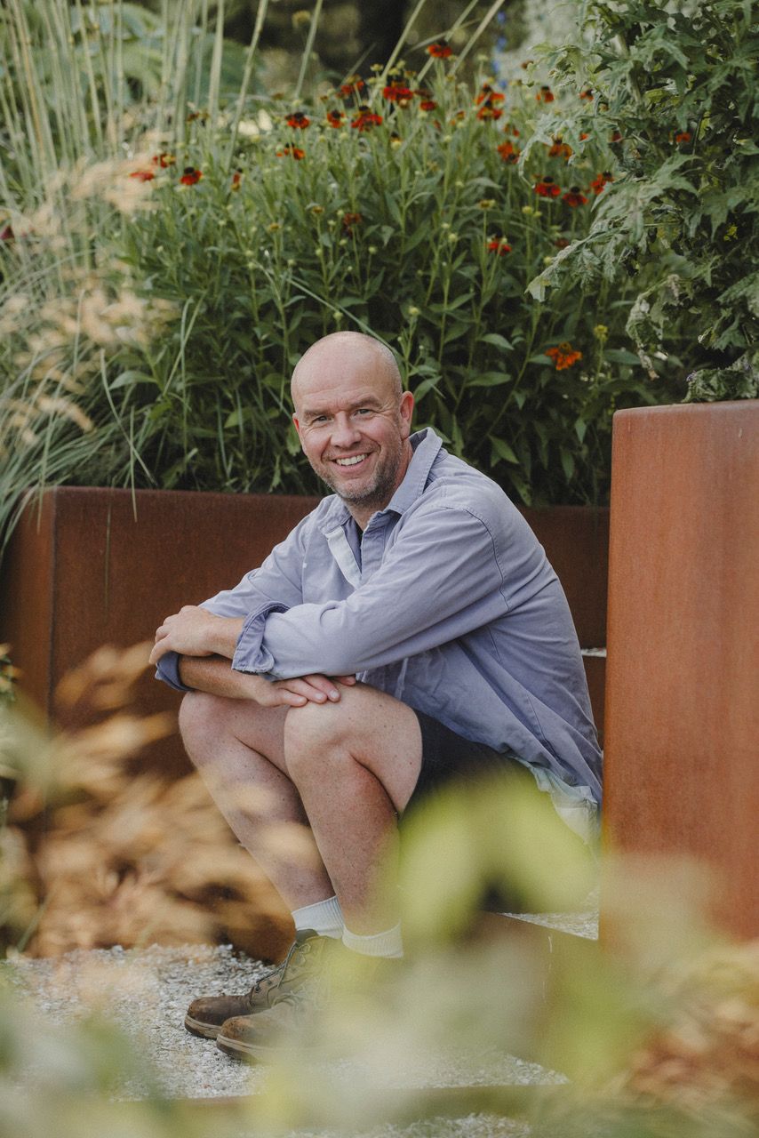 Image may contain Matt Haig Person Sitting Face Head Photography Portrait Plant Potted Plant and Adult