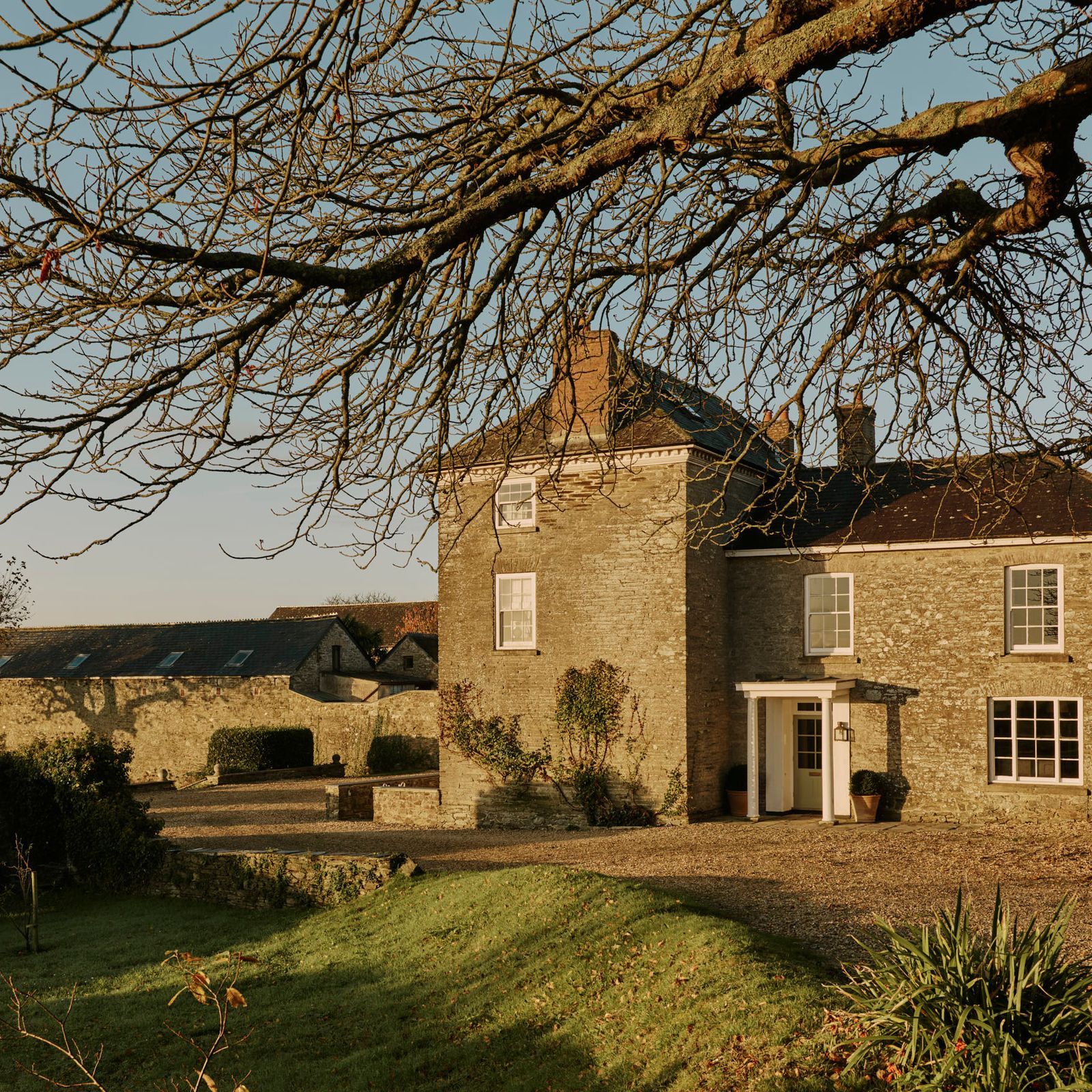 An 18th-century house by the sea in Devon refreshed with antiques and colour