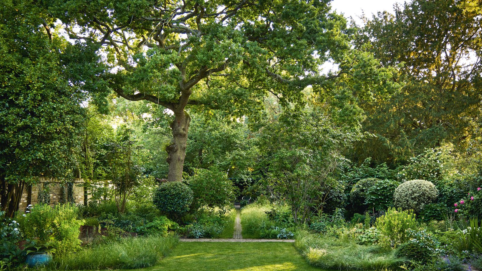 A perfectly crafted London garden with a tiny wildflower meadow and woodland