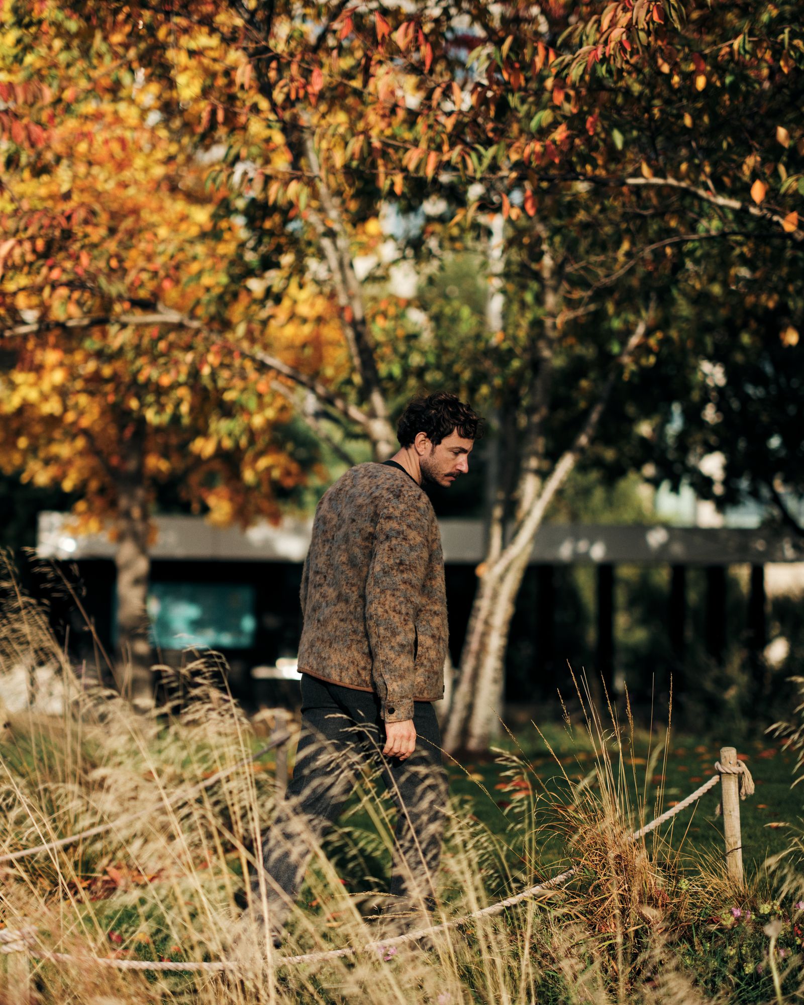 Image may contain Adult Person Clothing Pants Autumn Plant Tree and Sleeve